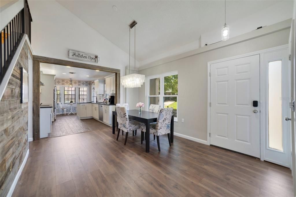 On a CORNER LOT this UPDATED HOME has LUXURY VINYL PLANK through the main floor for easy maintenance, a bright flowing floor plan and the living area features a VAULTED CEILING, modern FIREPLACE and sliding glass door access to the spacious SCREENED LANAI.