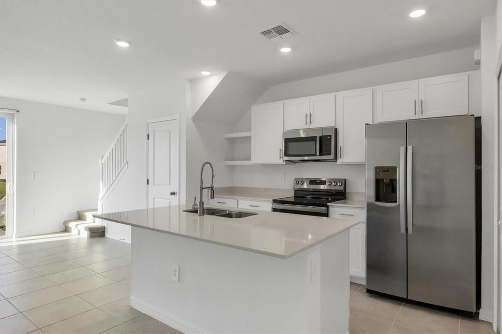 Quartz countertop, and matching stainless appliances!