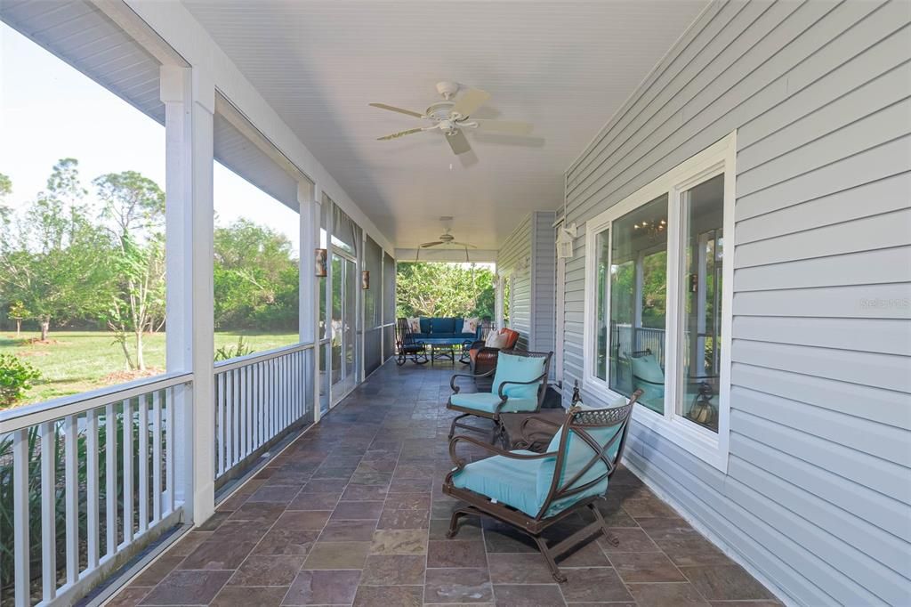 Relax on the charming front porch, furnished with weatherproof seating and a classic porch swing.