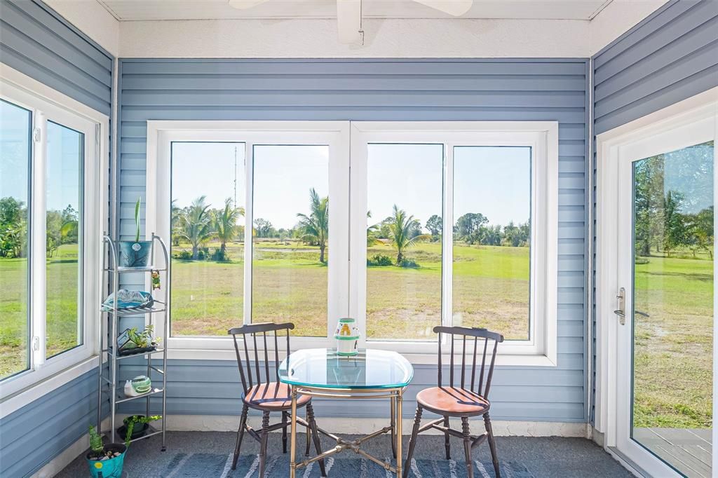 Cottage Sunroom overlooking the fountain in the pond.