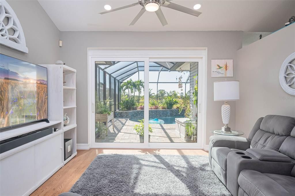 Open Living room with planter shelves, leading to pool deck