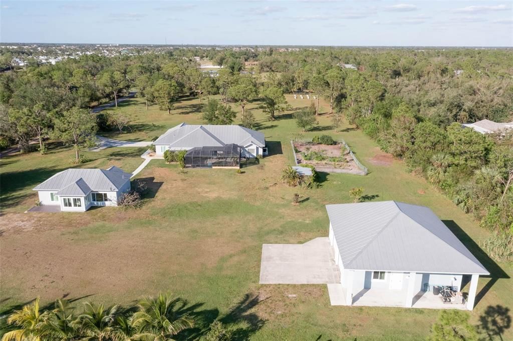 Large detached garage has covered patio area.