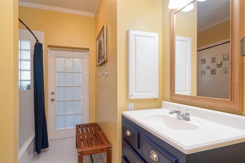 Bathroom with pool access via French doors with integrated blinds