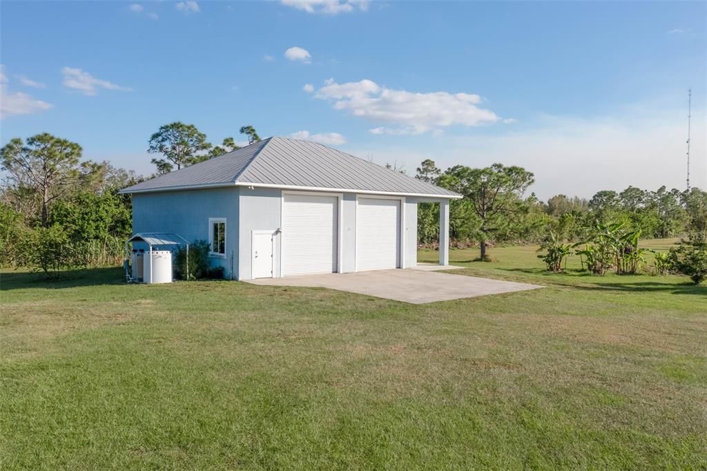 Oversized RV garage with large covered concrete pad