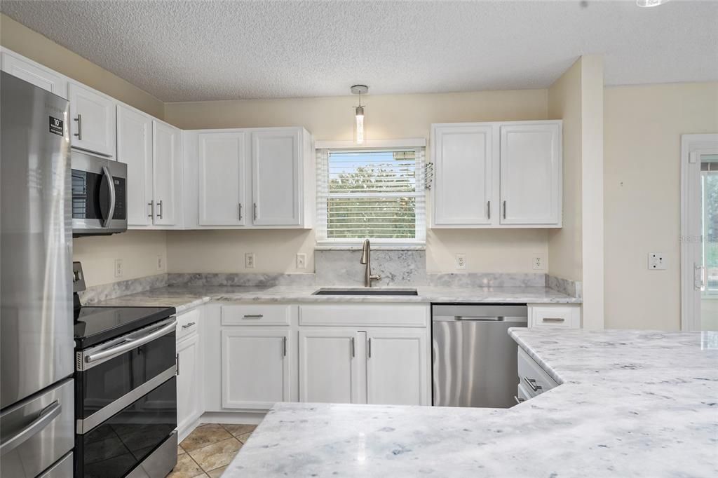 STAINLESS APPLIANCES AND WHITE CABINETS