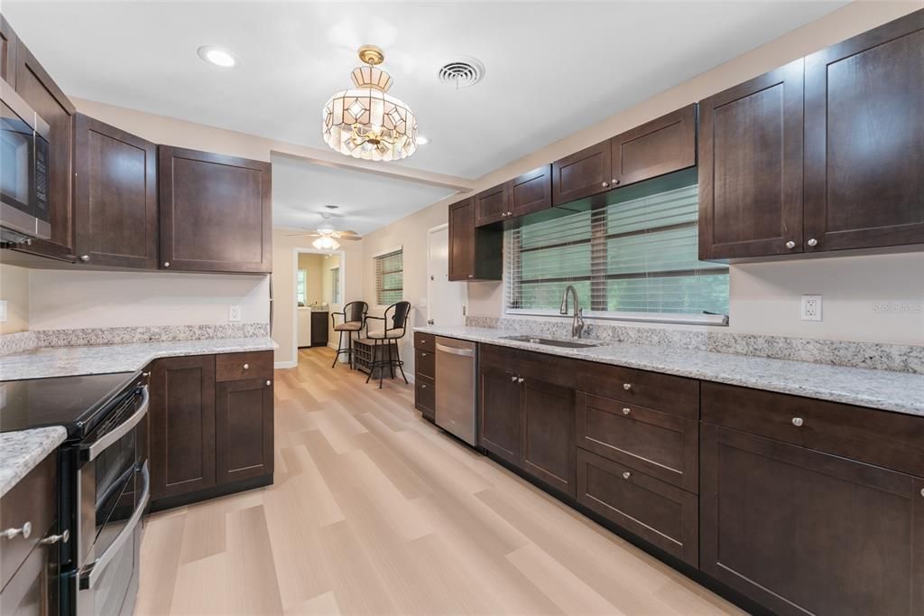 Wash Your Dishes While Looking Outside at the Covered Lanai & Green Space