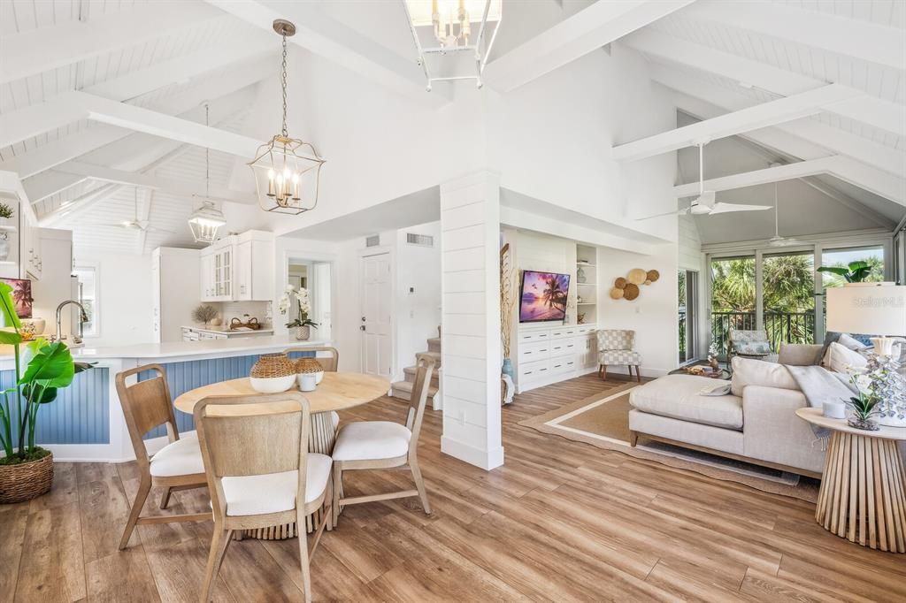 View of open concept kitchen/dining/living room from entry way. Gorgeous shiplap ceilings!