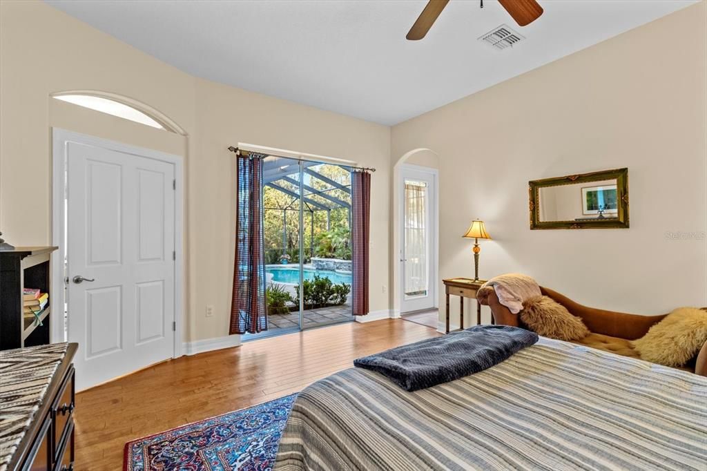 Master Suite #2 with sliders and view of pool/lanai