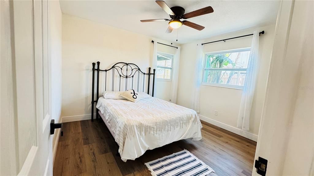 Bedroom #2 with queen bed and ceiling fan.