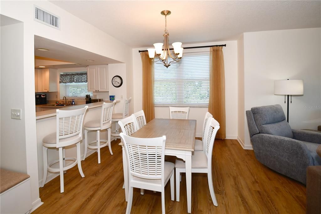 The Dining Room next to the Kitchen Breakfast Bar with bar stools.