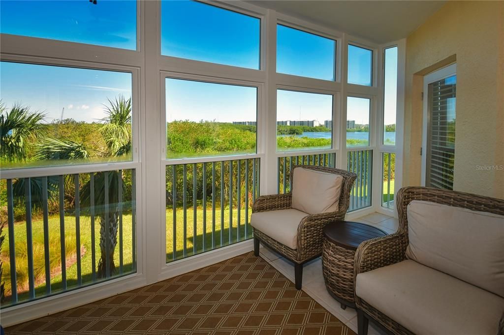 The enclosed lanai has great views and is protected from the weather with hurricane-impact windows that can be opened to let the breezes in.