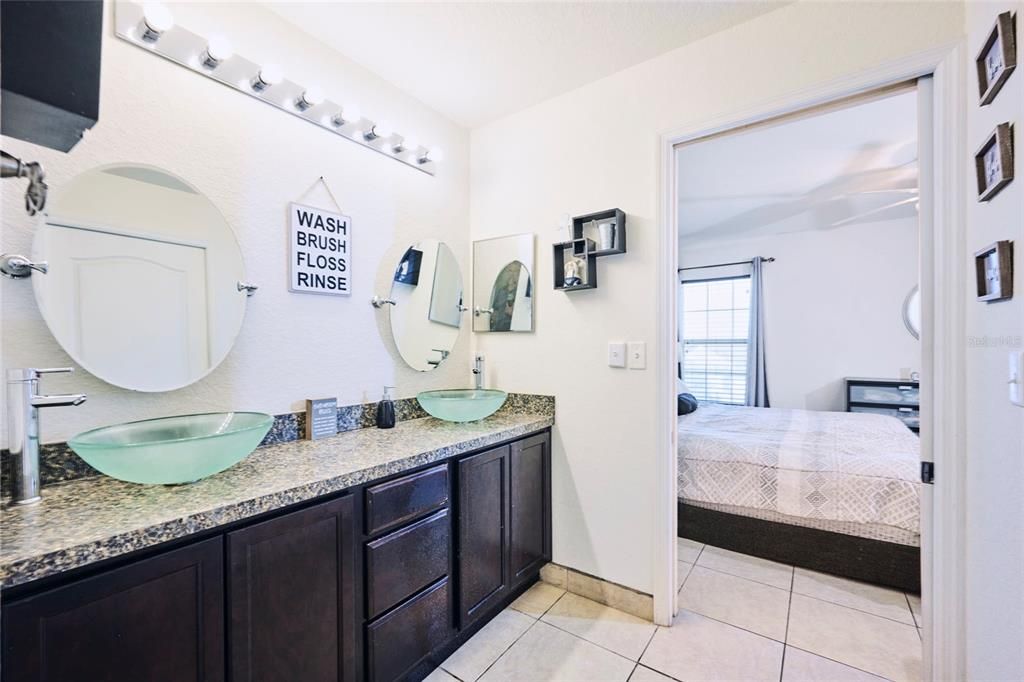 Master bathroom with view back into master bedroom