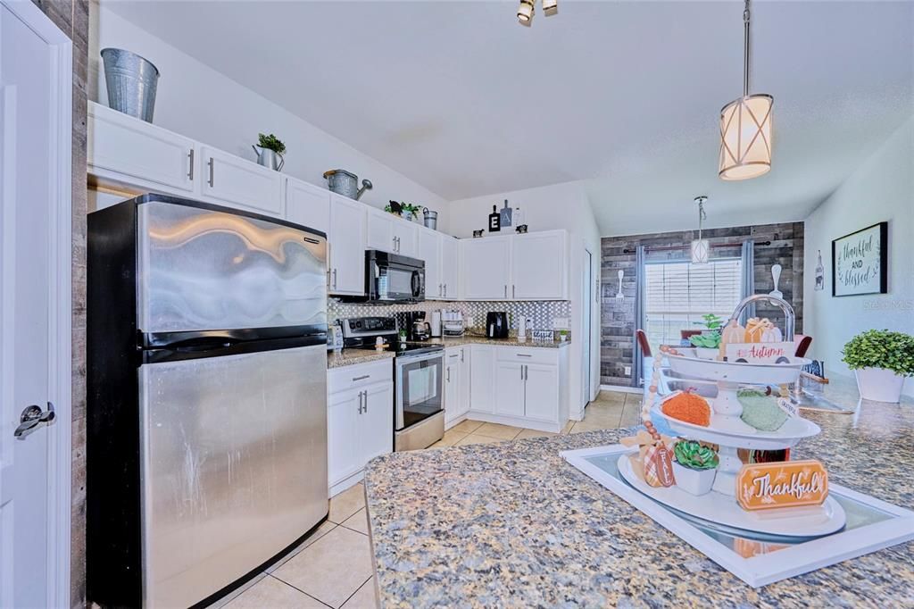 Kitchen has lots of cabinetry and counter space and breakfast nook.