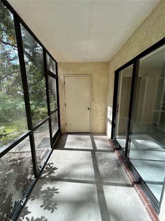 Rear screened porch with storage closet