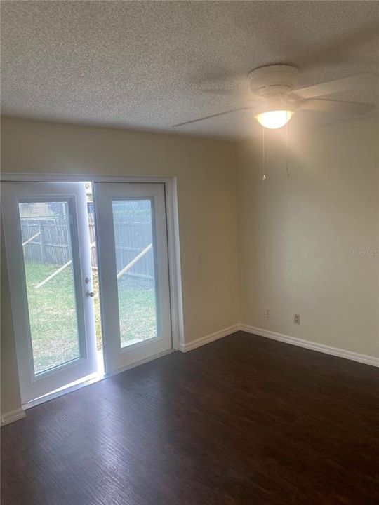 French doors in Master bedroom leading to fenced backyard