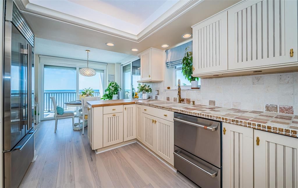 Contemporary Kitchen overlooking the Dining / Bonus Area - step out onto the HUGE Gulf front Balcony