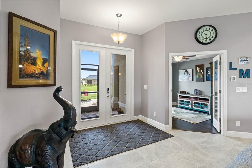 Foyer featuring french doors, hardwood / wood-style flooring, and ceiling fan