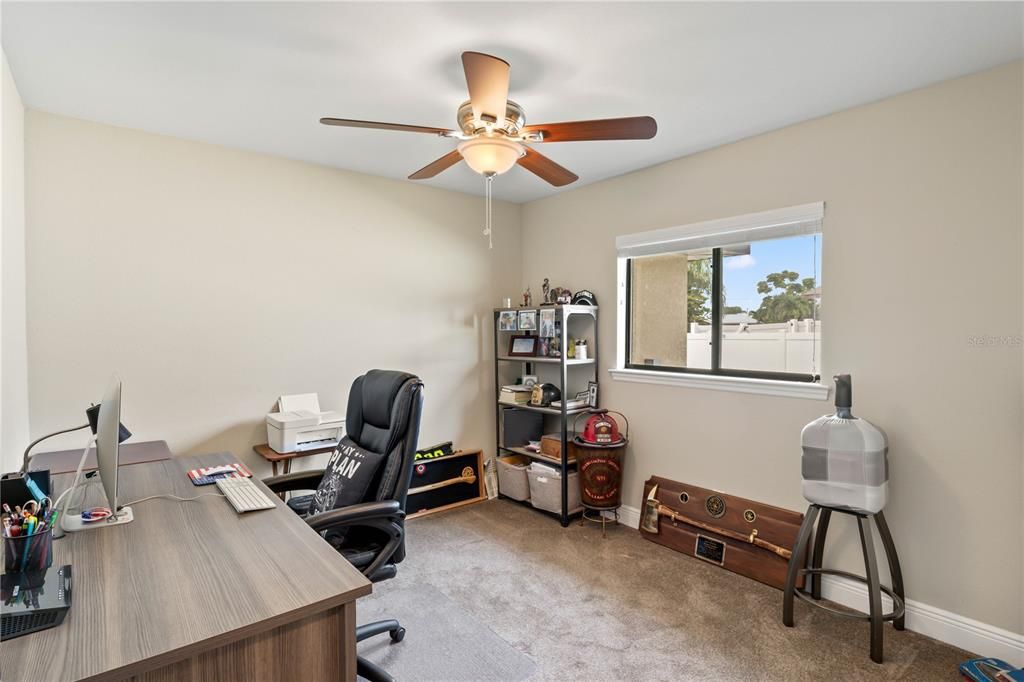 Carpeted home office with ceiling fan