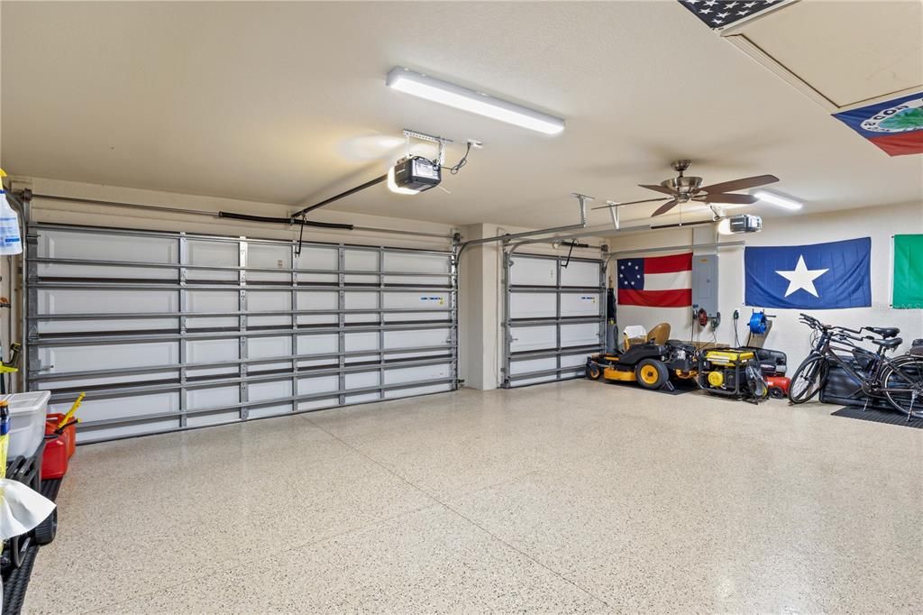 Garage featuring ceiling fan and a garage door opener