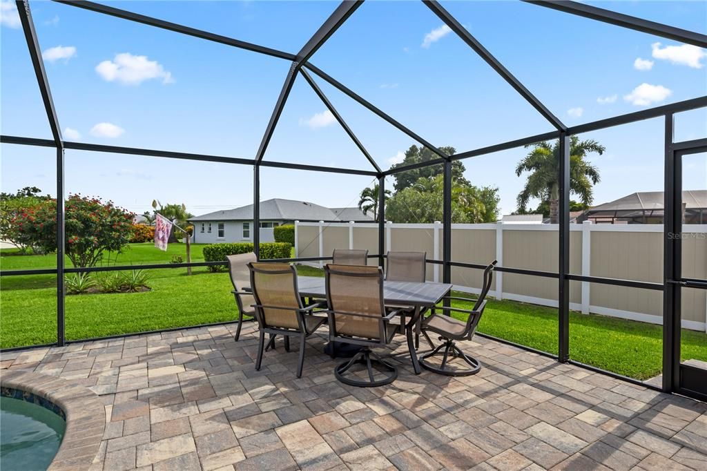 View of patio featuring a lanai