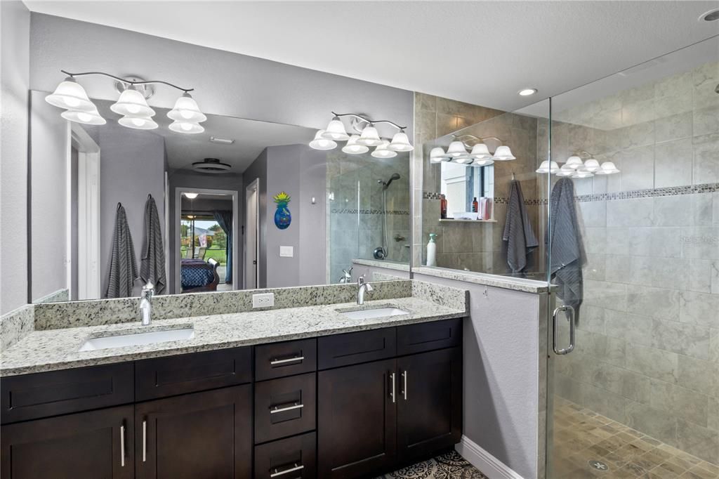 Bathroom featuring walk in shower and vanity