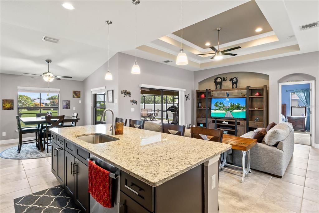 Kitchen with ceiling fan, plenty of natural light, sink, and stainless steel dishwasher