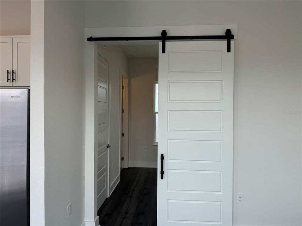 BARN DOOR SEPARATION FROM LIVING AREA AND ENSUITE BEDROOM WITH LARGE WALK-IN