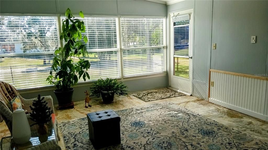 Florida Room overlooking the back yard and golf course.