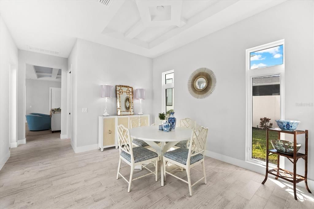 Dining area with coffered ceiling right off of the kitchen area.