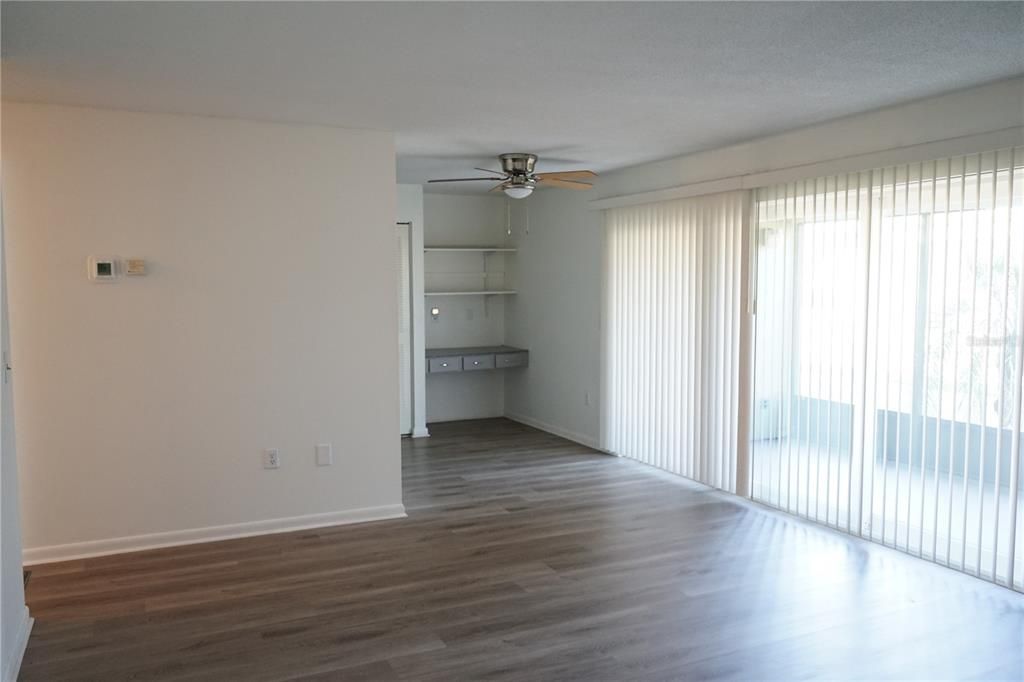 living room view to kitchen and built in desk