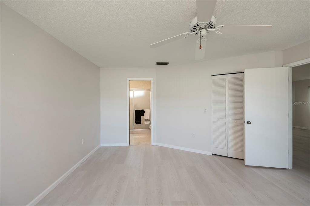 Door to en site and second door to walk-in closet in primary bedroom