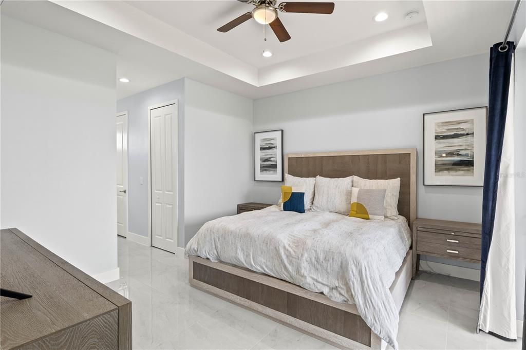 Bedroom featuring ceiling fan and a raised ceiling