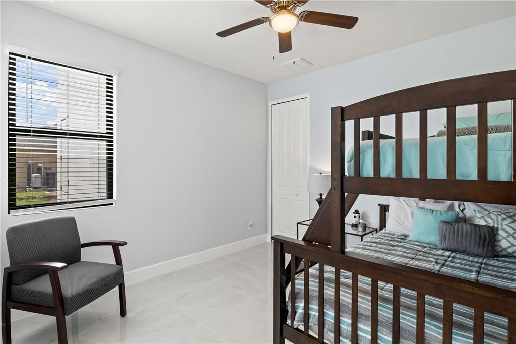 Bedroom featuring ceiling fan and a closet