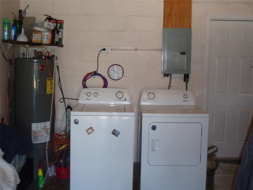 Garage showing water heater, washer, dryer