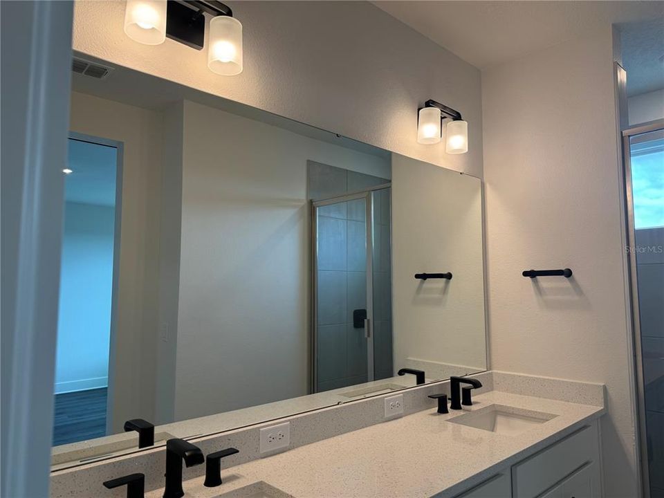 LUXURY QUARTZ, MODERN MATTE BLACK FIXTURES. TRANSOM WINDOW IN ALL SHOWERS