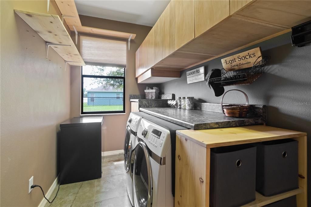 inside laundry room with cabinet storage and countertop space