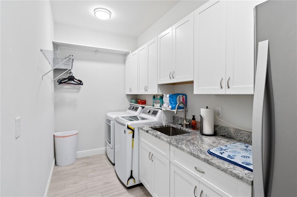 Not your ordinary average laundry room - this features a laundry tub and 32 inch uppers for storage!