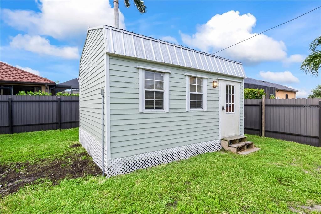 Large shed in back yard - has electric and can be used for multiple purposes - all on a concrete slab!