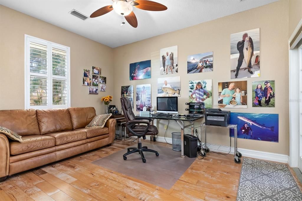 3rd Bedroom used as office/den. New Hickory wood flooring, plantation shutters, French doors with view of pool/canal, ceiling fain, custom closet, hard-wired electric line shades on sliding glass door.