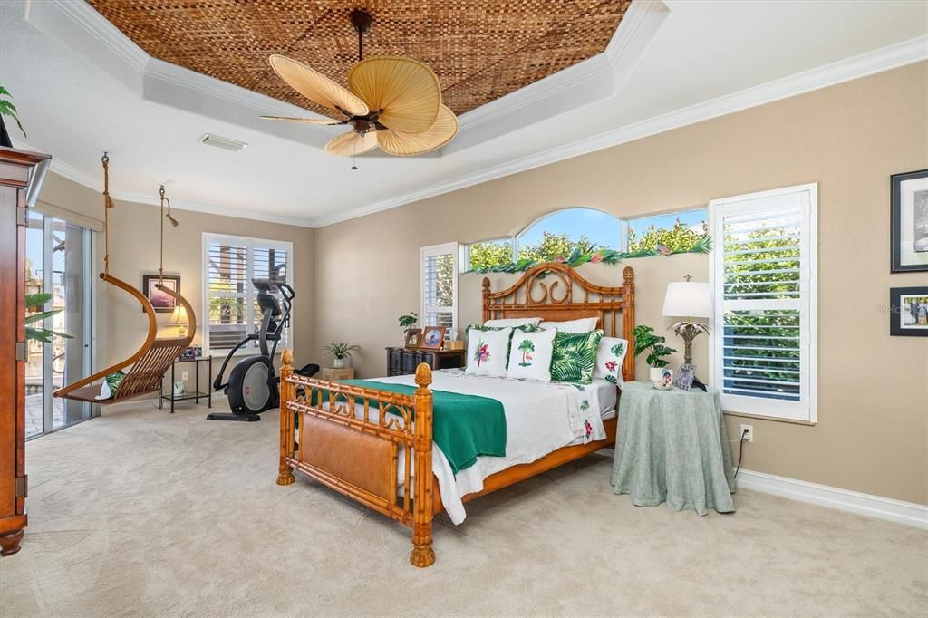 Large master suite with a separate sitting area, new carpeting in 2024, unique Tray ceiling with banana leaf inset