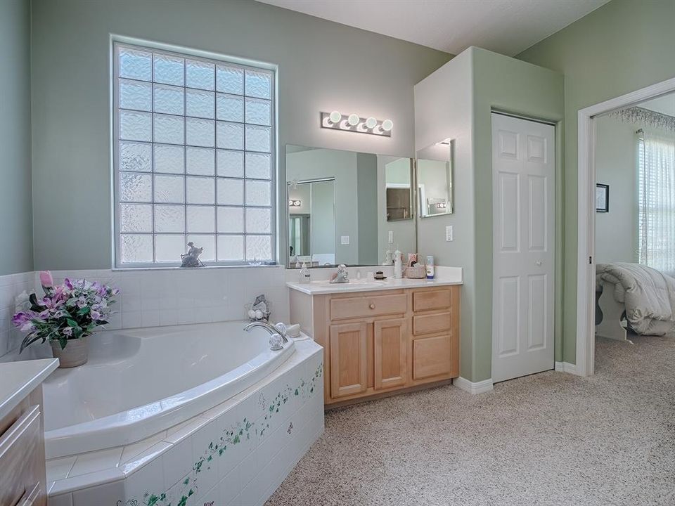 DUAL VANITIES, DUAL SINKS, LINEN CLOSET AND LOVELY GLASS-BLOCK WINDOW