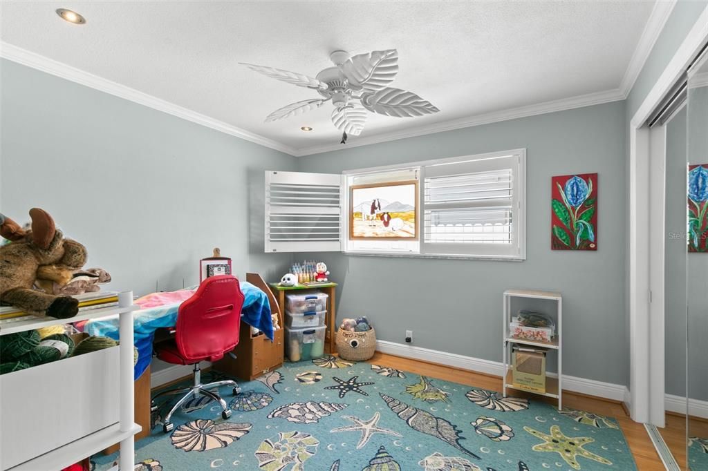 Fourth Bedroom has Plantation Shutters and mirrored closet doors.  This is on the same side of the home as the Primary Suite and would make an ideal nursery, office or fitness room!