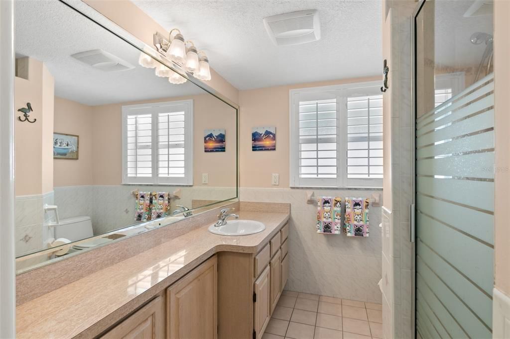 Hall Bath has a large vanity and lots of storage.