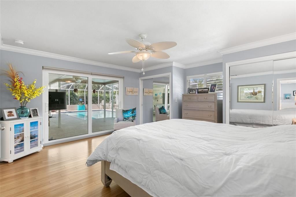 Primary Suite with newer impact glass sliding doors to the Pool and Lanai.