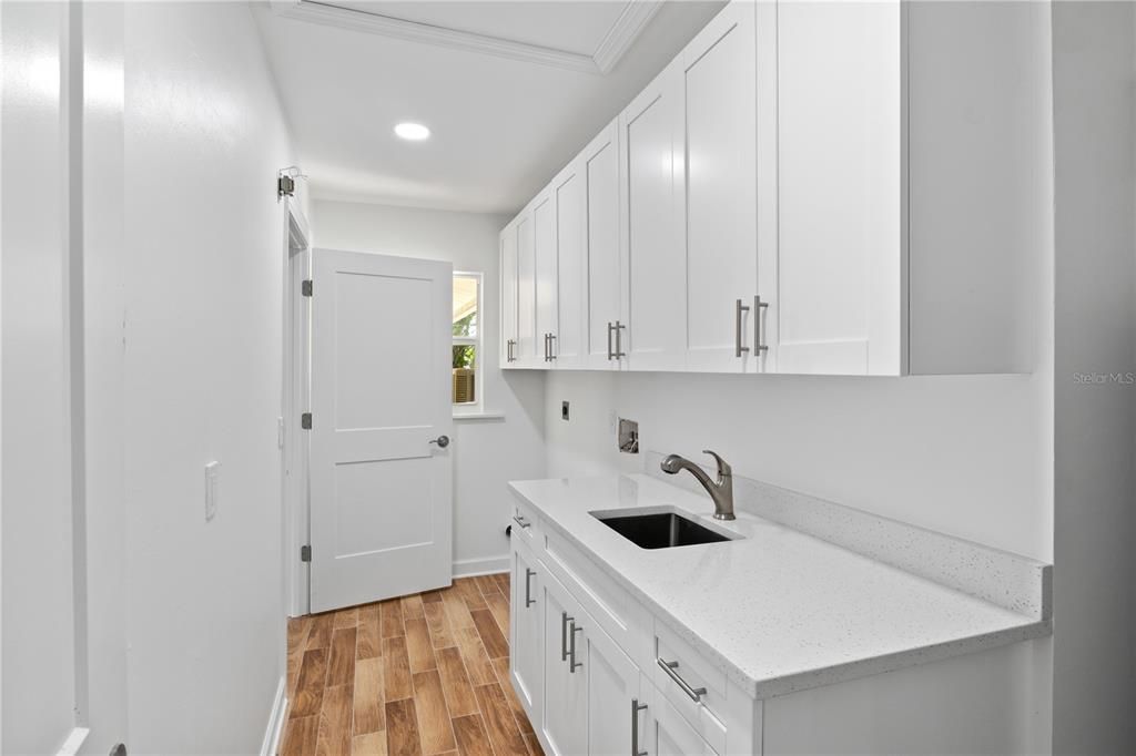 The laundry room is also large and offers spacious cabinets and drawers for storage!