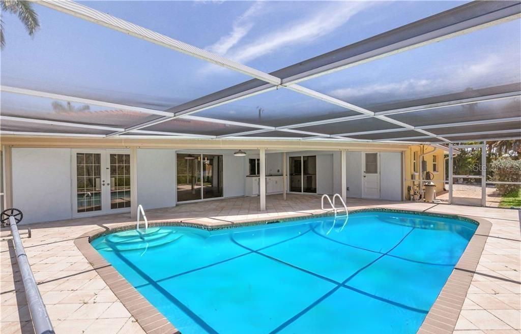 View of pool featuring a patio and a lanai