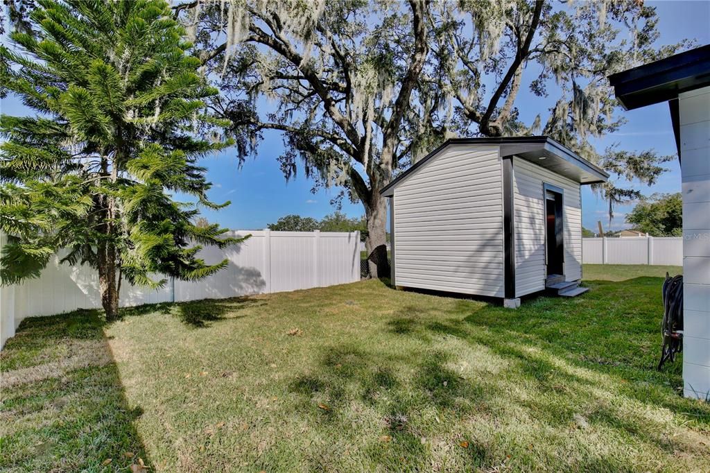 Outdoor workshop and storage shed w/full electrical hookups. Aproximately 9.6 x 15.3.