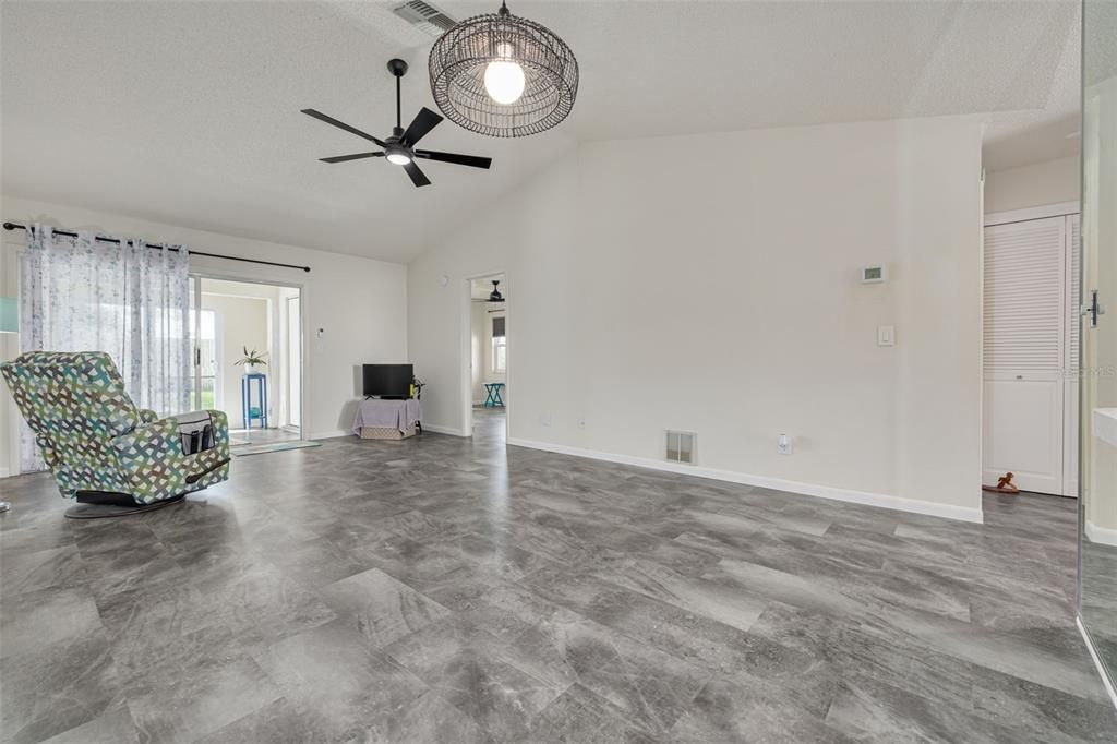 Living Room with Vaulted Ceiling and View of Split Bedroom Plan - Primary on Left and Bedroom 2 on Right