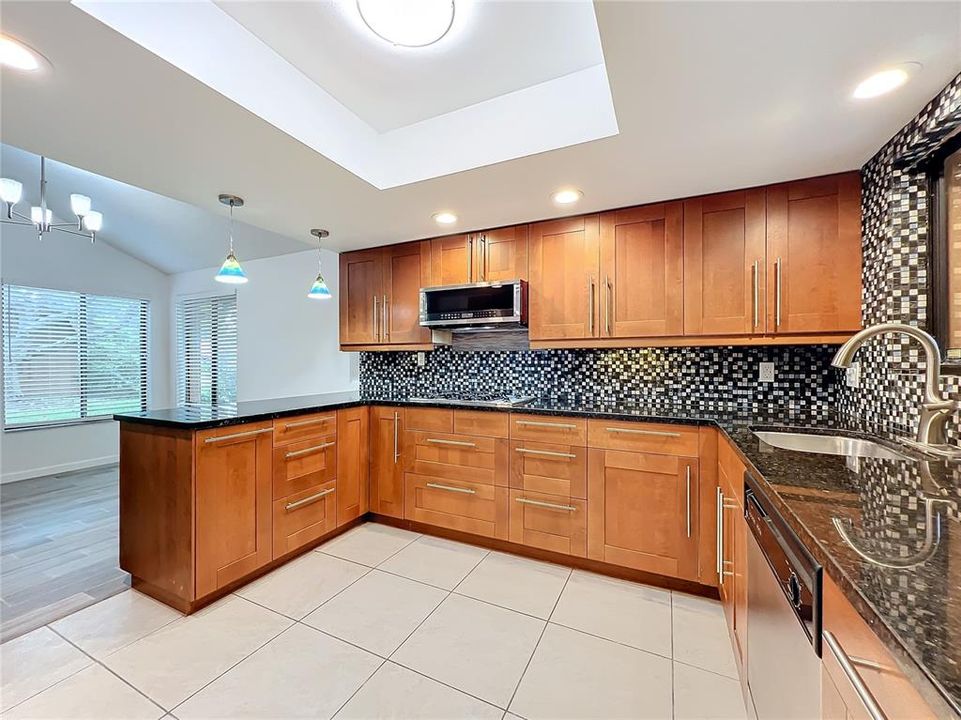 Open concept kitchen with stainless steel appliances.