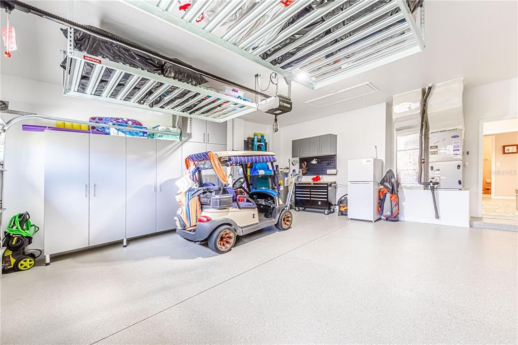 New garage makeover!  Note the overhead storage and custom cabinets on the left; new epoxy floor